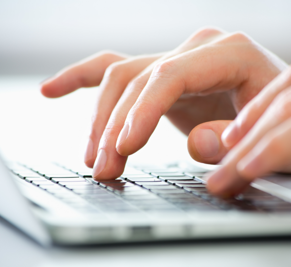 A man typing on a laptop