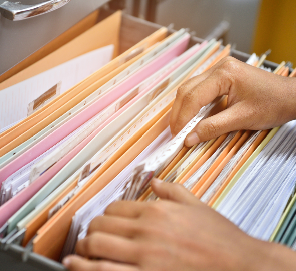 A man sorting through a file cabinet